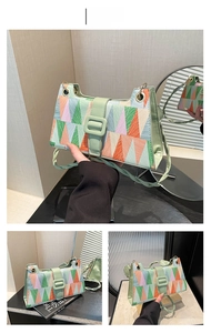 Detail of colorful geometric pattern and green buckle closure on chic shoulder bag