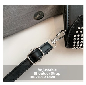 Détail de la bandoulière réglable en cuir et boucle argentée d'un sac à main clouté noir