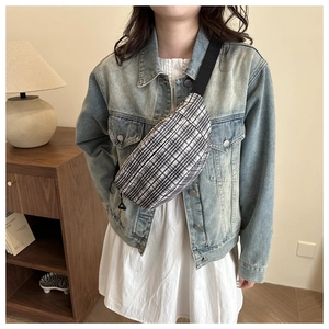 Close-up of minimalist black and white checkered canvas chest bag with adjustable strap