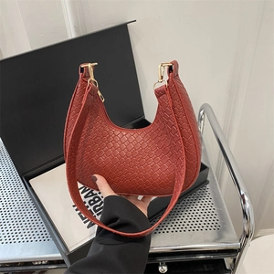 French woven crescent moon hobo bag in reddish-brown leather with gold metal buckle