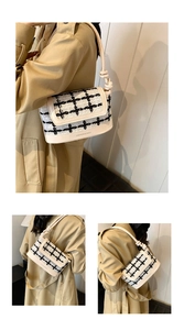 Detail of checkered tweed flap and cream leather base with a unique knotted shoulder strap