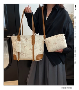 Detailed set of three tote bags featuring cream canvas and brown leather handle accents