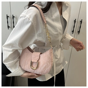 Detail of light pink hobo bag with pleated texture and gold D-ring hardware clasp