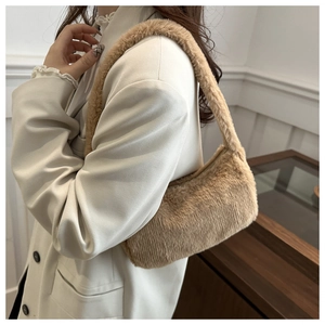 Close-up of the plush khaki faux fur texture and matching shoulder strap on the bag