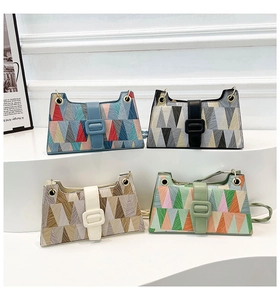 Detail view of colorful geometric patchwork shoulder bags in four diverse color palettes
