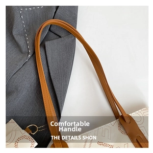 Close-up of brown leather handle and patterned tote bag with a matching small coin purse