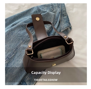 Interior view showing capacity of dark brown shoulder bag with phone and wallet