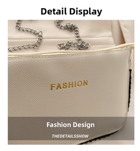 Detail of cream lychee leather texture and gold FASHION lettering on a small crossbody bag