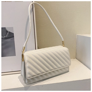 Détail du sac matelassé blanc en similicuir avec coutures élégantes et fermoir doré chic