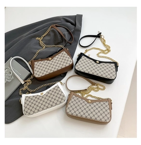 Detail showing vintage print crossbody bags with gold floral clasps and chain straps