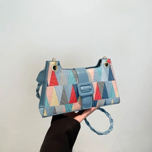 Geometric patchwork underarm bag with blue leather trim and colorful triangle patterns