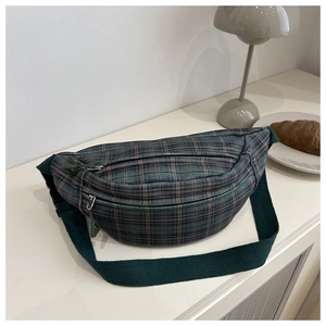 Detail of vintage plaid corduroy waist bag with adjustable strap and metal zipper