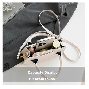 Vue intérieure montrant la capacité du sac en cuir crème avec téléphone et gloss à lèvres