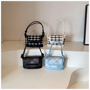 Detailed view of quilted tweed and denim crossbody bags with knot strap and logo text
