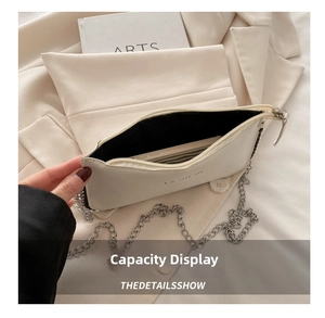Detail of a beige pebbled leather crossbody bag showing spacious interior for smartphones