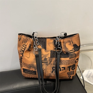 Chic tote bag with newspaper print and silver chain strap for casual daily use