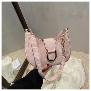 Detail of pink pleated faux leather shoulder bag with golden horseshoe D-buckle hardware