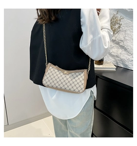 Detailed view of vintage monogram shoulder bag with gold chain strap on model