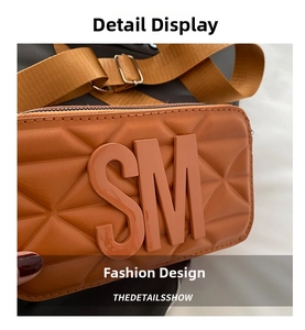 Close-up of caramel quilted PU leather crossbody bag with SM logo and wide strap