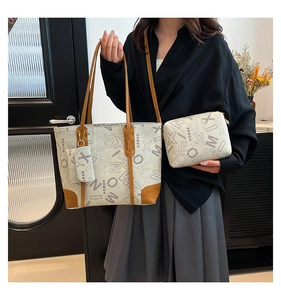 Three-piece printed canvas tote bag set with brown leather trim and matching card holder