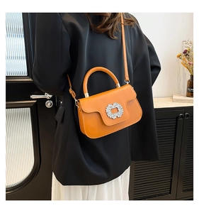 Détail du sac bandoulière jaune gingembre avec boucle strass et sangle ajustable