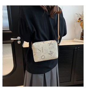 Detail of vintage beige tote bag with black letter print and slim brown strap