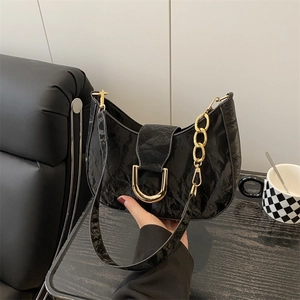 Minimalist black pleated hobo bag with gold hardware and chain detail for women
