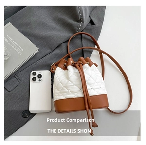 Detail of drawstring bucket bag with contrast stitching and quilted leather texture