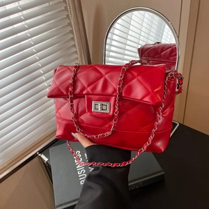 Red quilted leather chain bag with silver twist lock and woven shoulder strap