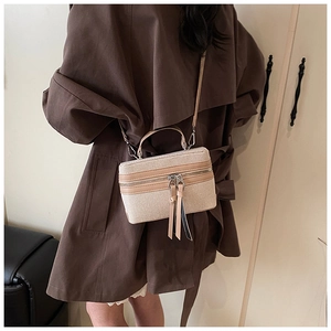 Detail of vintage canvas and leather box bag with dual metal zippers and long pull tabs