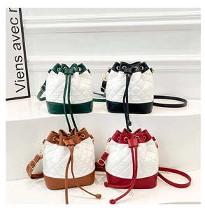 Macro detail showing colorful quilted bucket bags with gold metal hardware and drawstrings