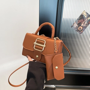 Brown lychee leather handbag with shoulder strap and matching mini pouch set