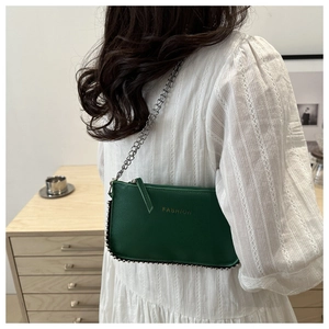 Detail of dark green leather crossbody bag with silver bead chain and fashion logo