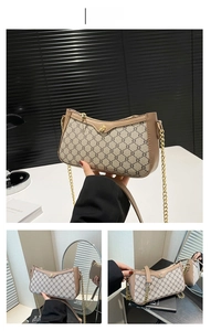 Detail of khaki monogram shoulder bag with gold chain strap and metallic twist lock