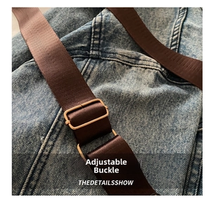 Detail of adjustable gold buckle on stylish denim bag with wide brown shoulder strap