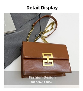 Detail of vintage brown oil wax leather bag with gold chain and geometric clasp