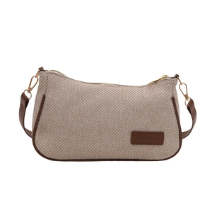 Minimalist oatmeal twill woven shoulder bag with brown leather trim and gold metal hardware