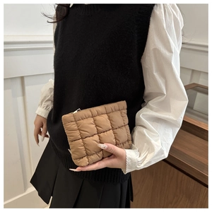 Detail of khaki quilted bubble clutch bag showing 3D puffy texture and square pattern