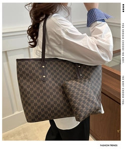 Detail view of stylish dark brown tote bag with letter print and matching inner pouch
