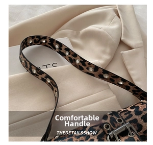 Detail of leopard print shoulder bag featuring metal eyelet strap and glossy texture