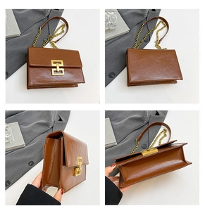 Detail view of brown glossy shoulder bag with gold chain strap and metal lock closure