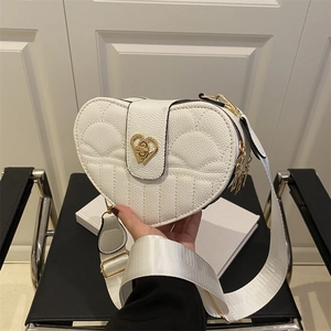 White heart-shaped crossbody bag with quilted patterns and gold metal heart lock