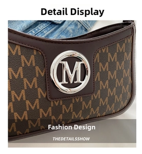 Macro detail of retro dark brown leather bag with silver M buckle and monogram texture
