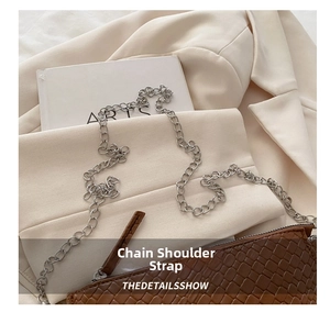 Close-up of woven shoulder bag in dark brown with textured silver chunky metal chain strap