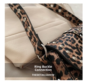 Close-up of leopard print bag with silver buckles and metal rivets detail
