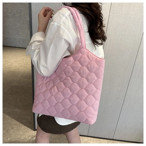 Detail of pink quilted tote bag with soft cloud texture and spacious design for women