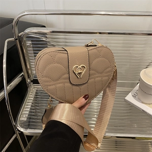 Quilted heart-shaped crossbody bag with litchi texture and golden metal twist lock