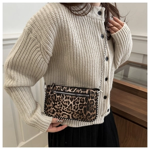 Detail showing leopard print pattern and silver stud embellishments on a crossbody bag