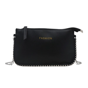 Minimalist black leather crossbody bag with silver rivets and metal chain strap