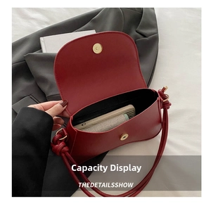 Internal view of burgundy leather shoulder bag showing spacious storage and magnetic closure